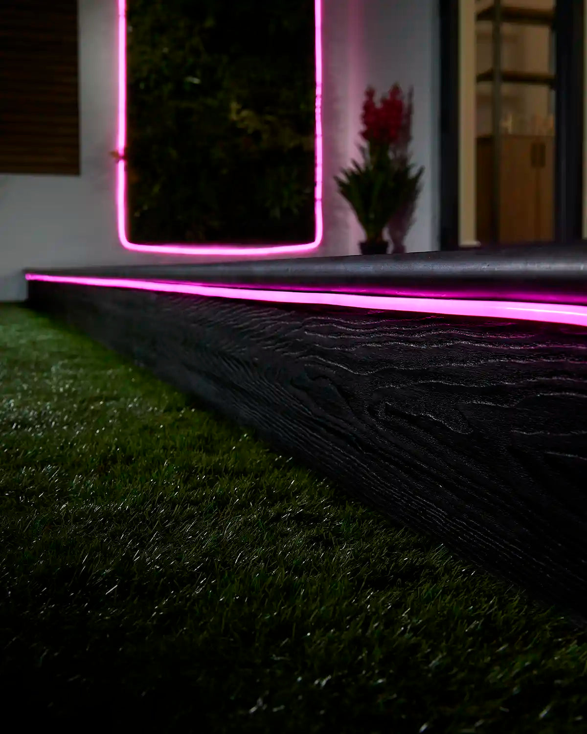 Pink Pro Series Neon Flex installed along outdoor decking and a wall feature.