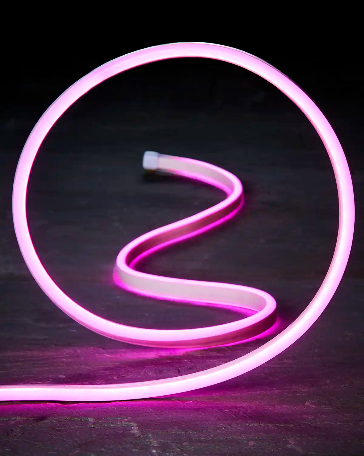 Close-up of flexible pink Neon Flex lighting shaped into a loop.