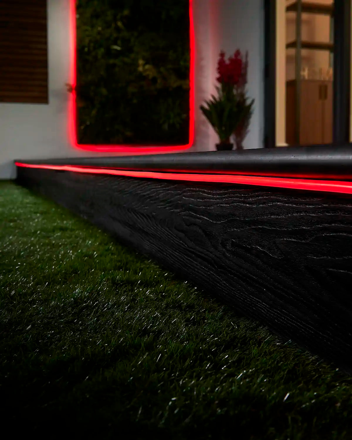 Red Pro Series Neon Flex installed along outdoor decking and a wall feature.
