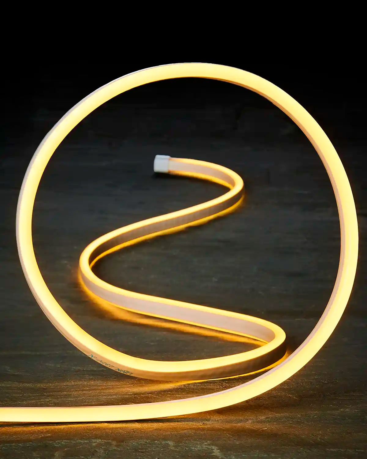 Close-up of flexible warm white Neon Flex lighting shaped into a loop.