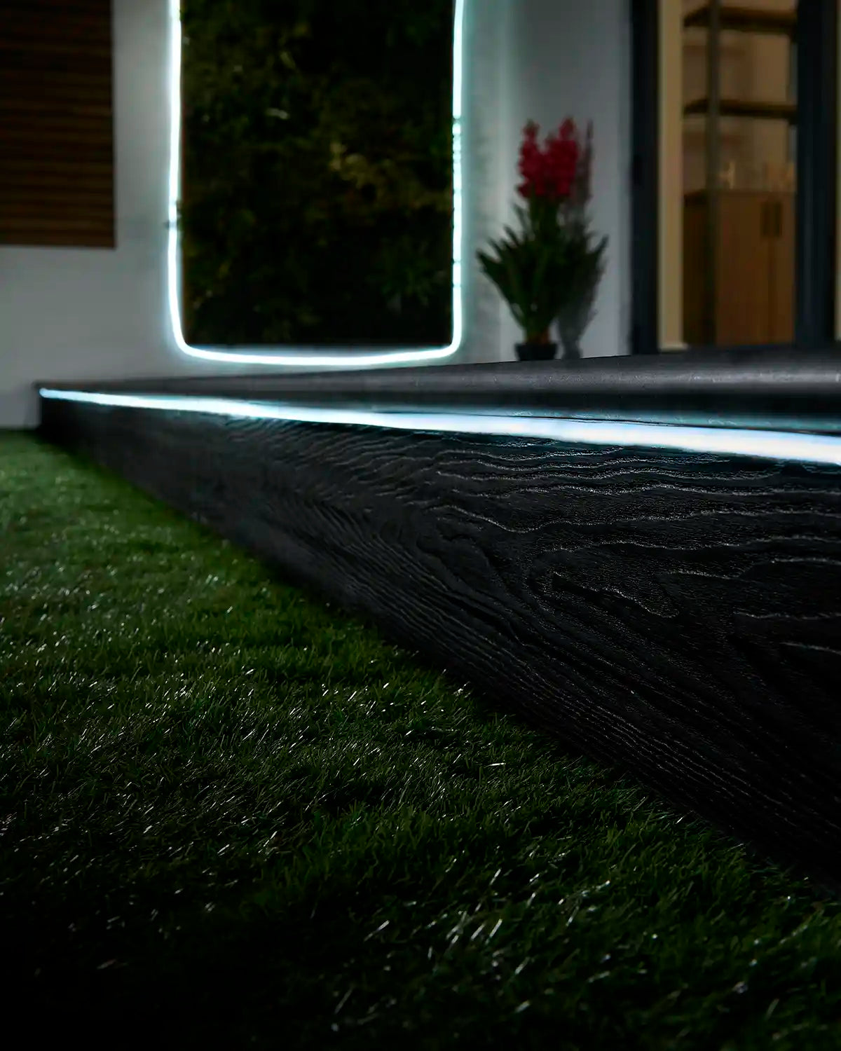 White Pro Series Neon Flex installed along outdoor decking and a wall feature.