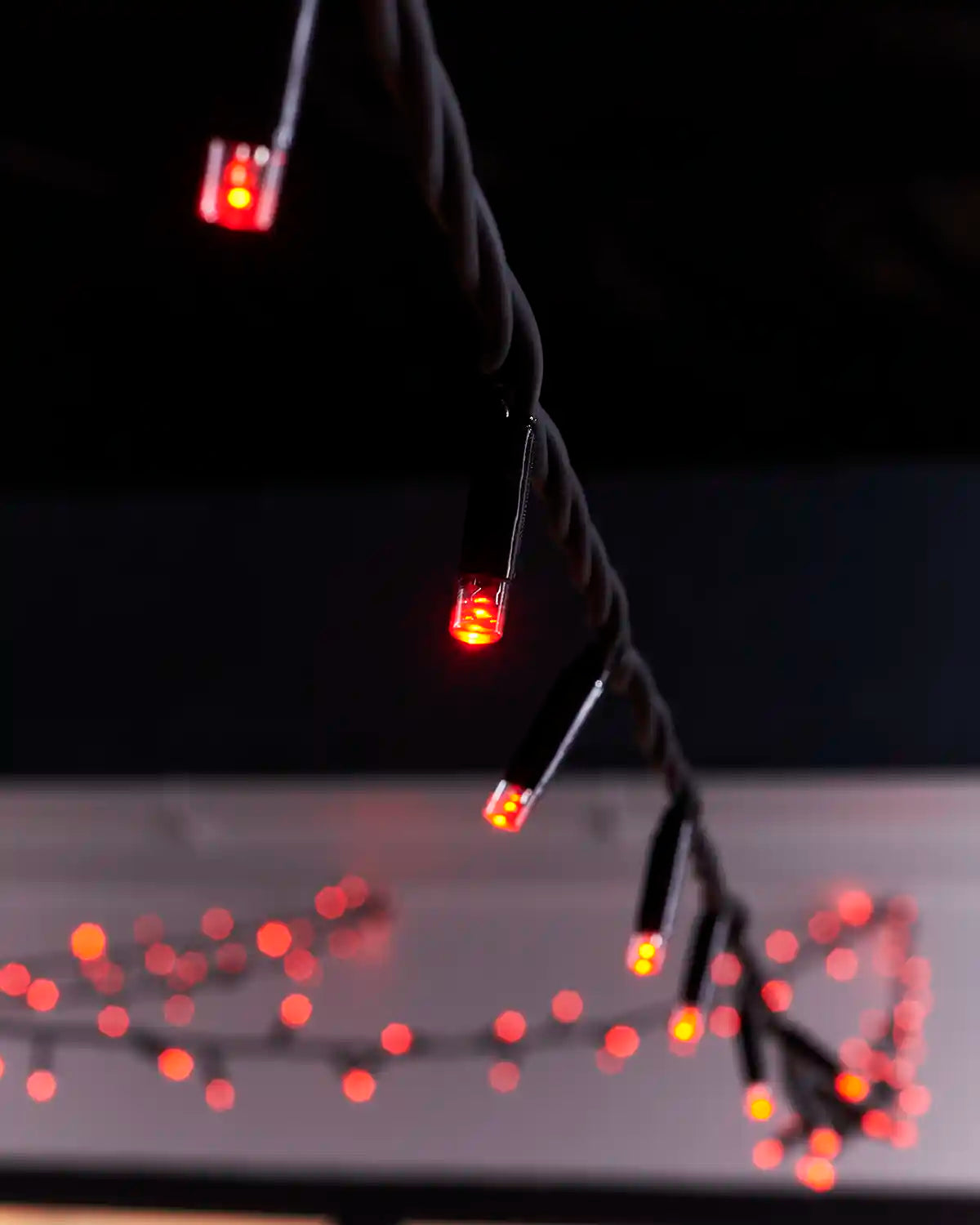 Close-up of red LED bulbs on black Pro Series string light cable.