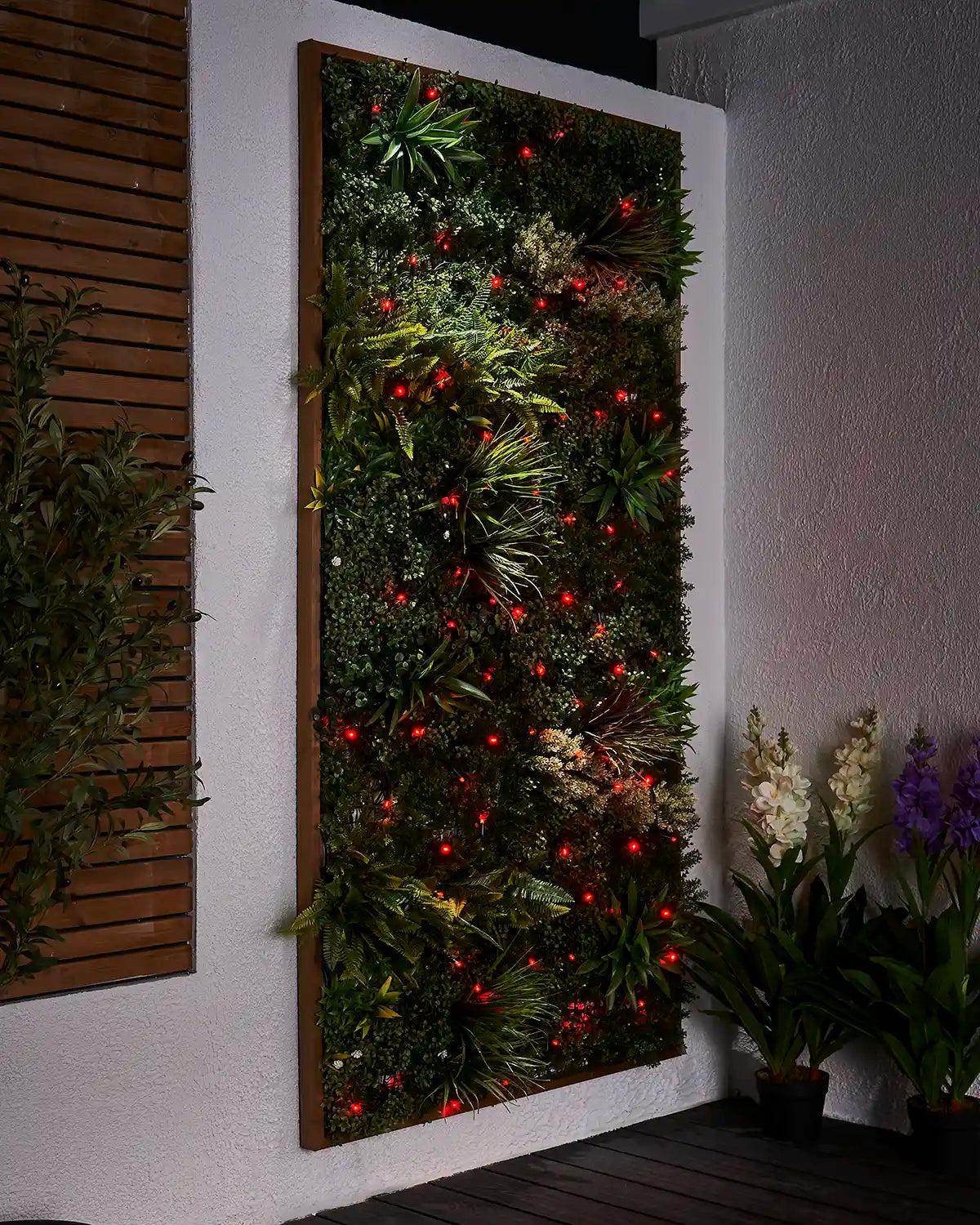 Red Pro Series string lights displayed across a green outdoor living wall.