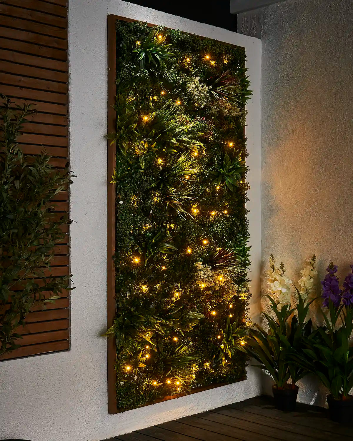 Warm white Pro Series string lights displayed across a green outdoor living wall.
