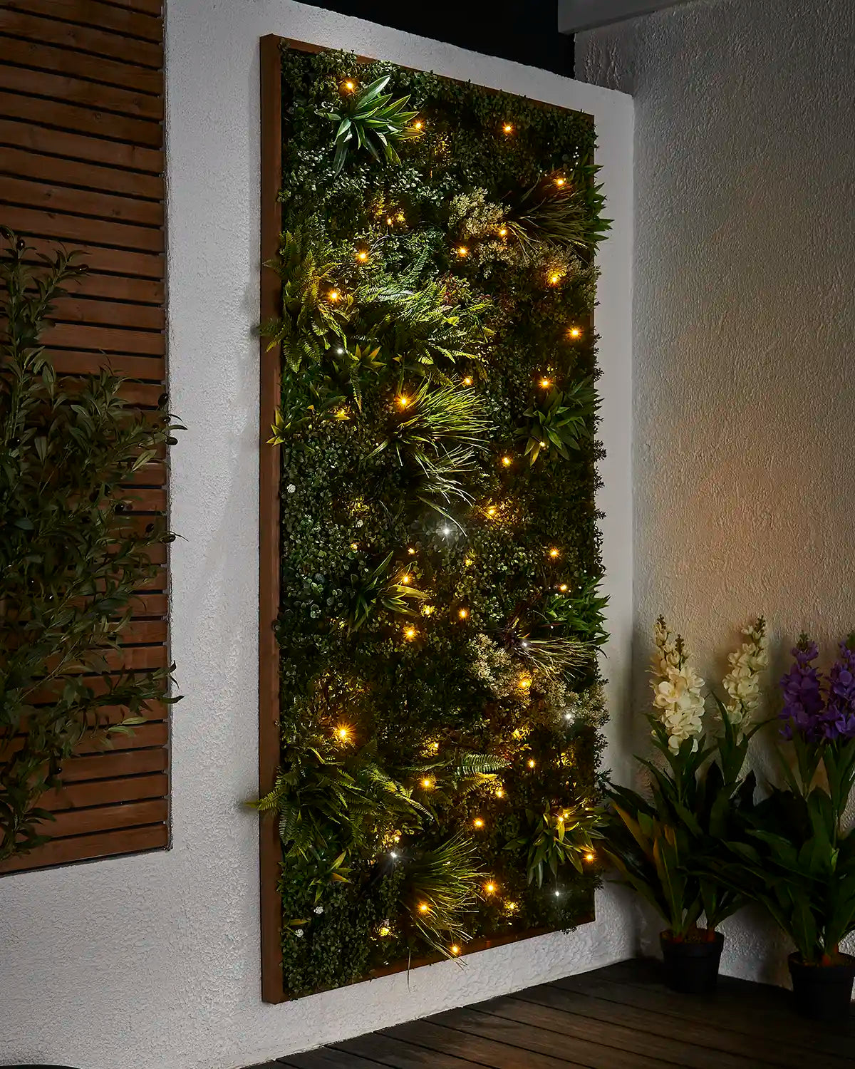 Mixed warm white and white twinkle string lights set into a living wall display.