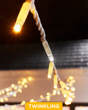 Close-up of mixed warm white and white twinkle string lights on white cable.