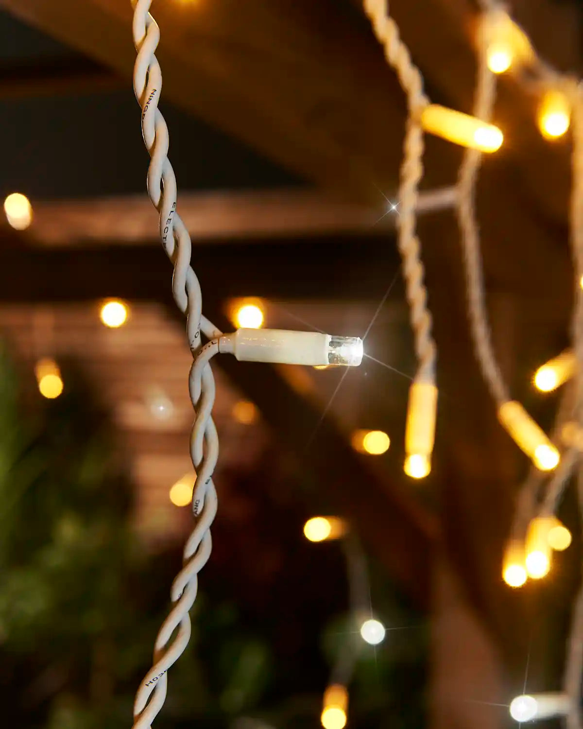 Close-up of warm white and white LEDs on white cable from Pro Series twinkling icicle lights.