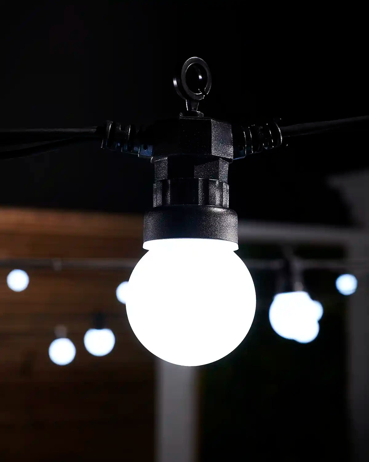 Detailed close-up of a white frosted festoon bulb with black cable and hanging hook.