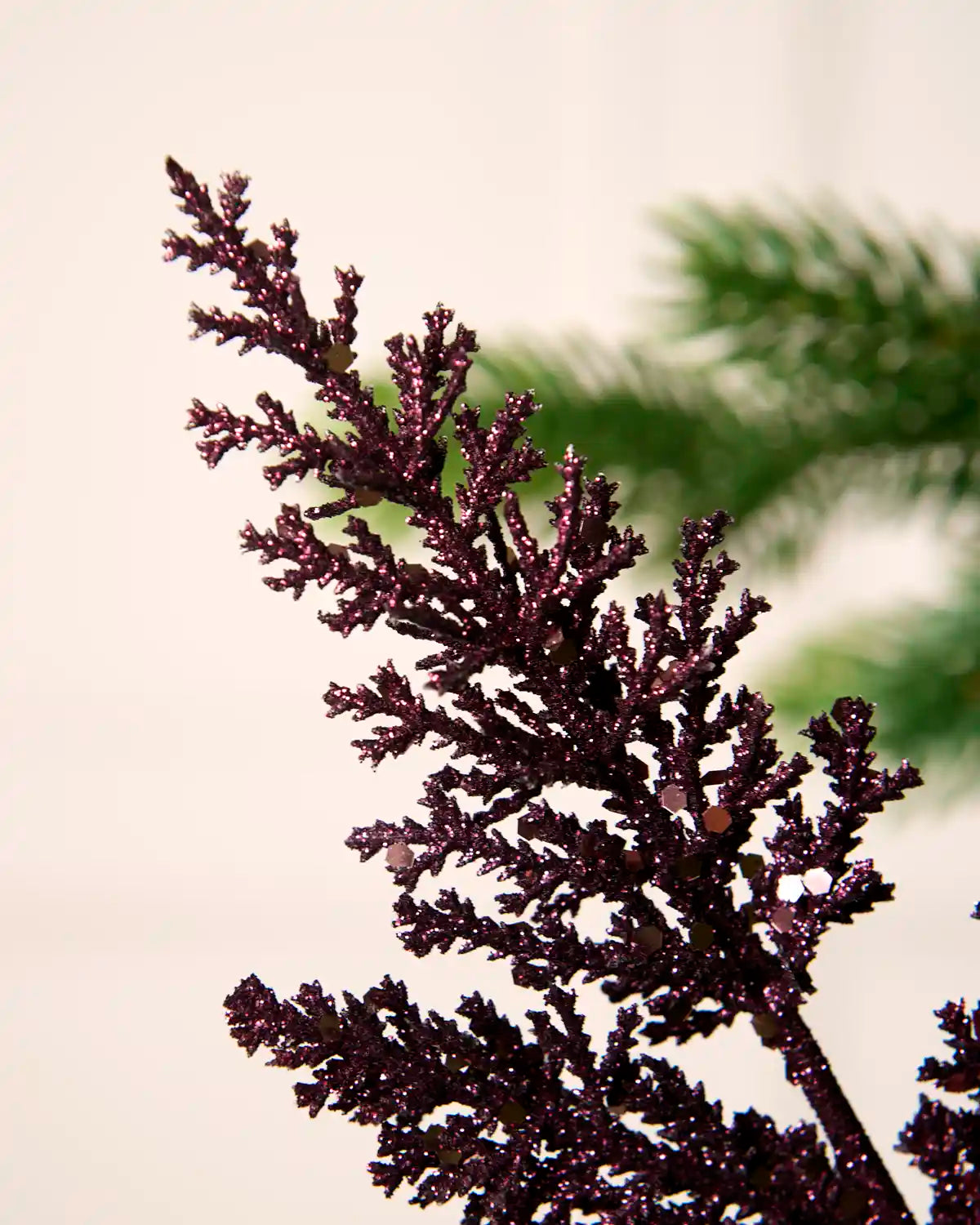 Close-up of the tip of a purple glitter leaf pick with a sparkling textured finish.