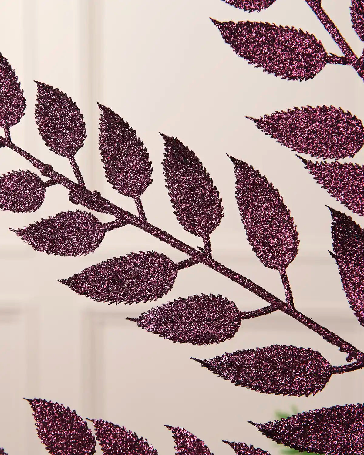 Close-up of the glitter-coated purple leaves on the Christmas tree spray.