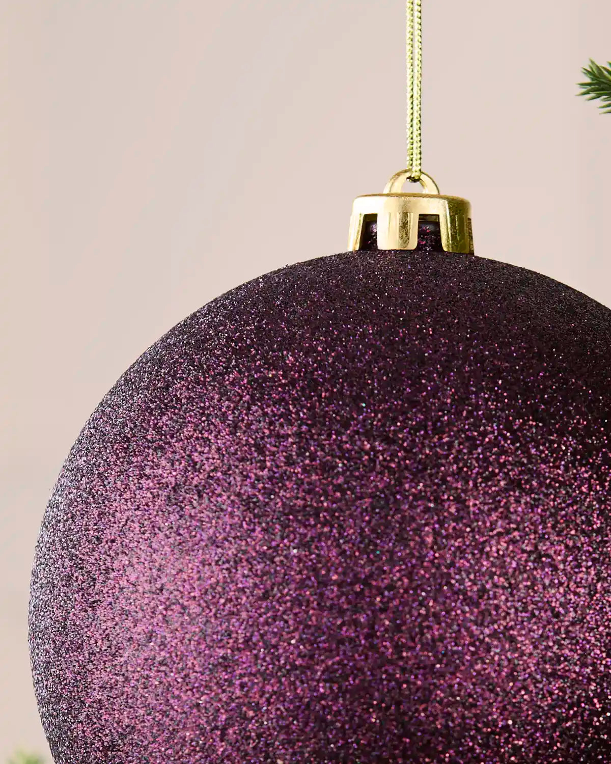Detailed close-up of the 15 cm purple glitter shatterproof bauble showing the gold cap, hanging string and sparkling finish.