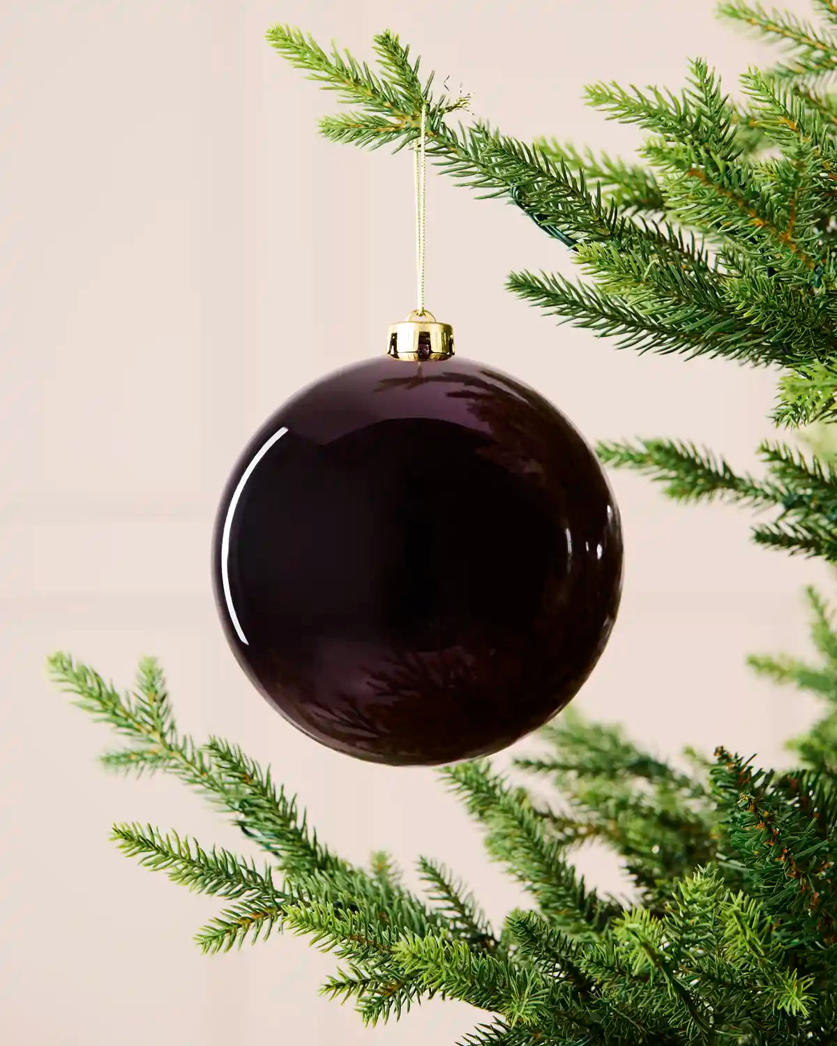 Purple 15 cm oversized shatterproof bauble with a shiny finish, gold cap and hanging string displayed on a Christmas tree.