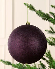 Purple 20 cm oversized shatterproof bauble with a glitter finish, gold cap and hanging string displayed on a Christmas tree.