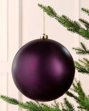 Purple 20 cm oversized shatterproof bauble with a smooth matt finish, gold cap and hanging string displayed on a Christmas tree.