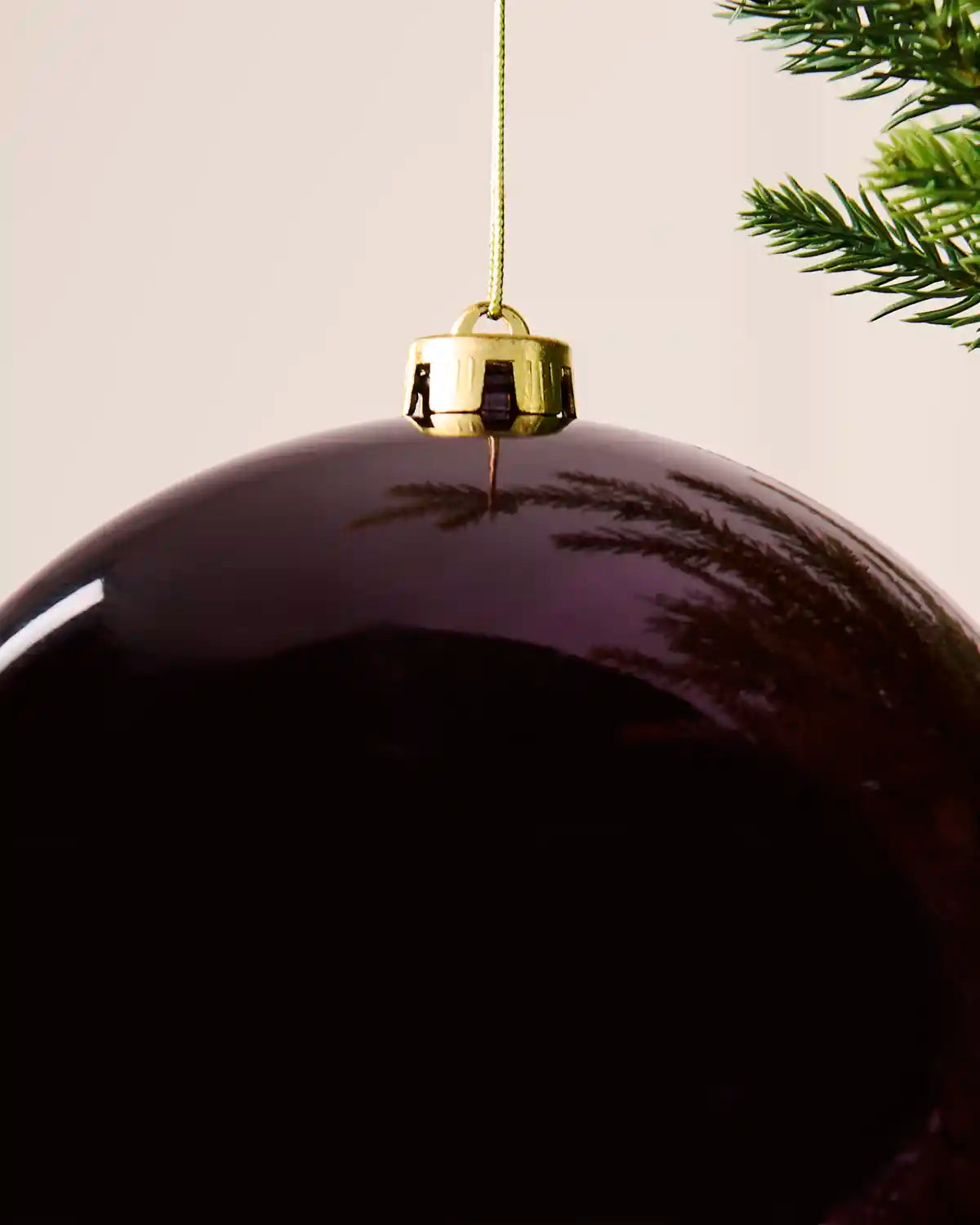 Detailed close-up of the 20 cm purple shiny shatterproof bauble showing the gold cap, hanging string and glossy finish.