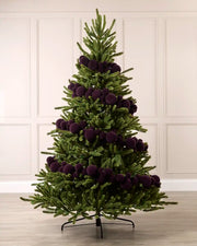 Purple velvet bauble garland wrapped around a green Christmas tree with mixed 5cm, 7cm and 10cm baubles.