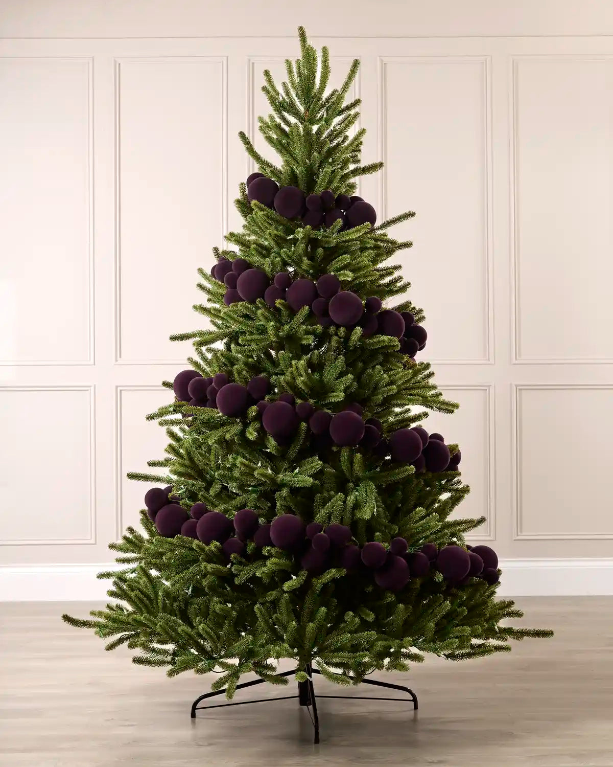Purple velvet bauble garland wrapped around a green Christmas tree with mixed 5cm, 7cm and 10cm baubles.