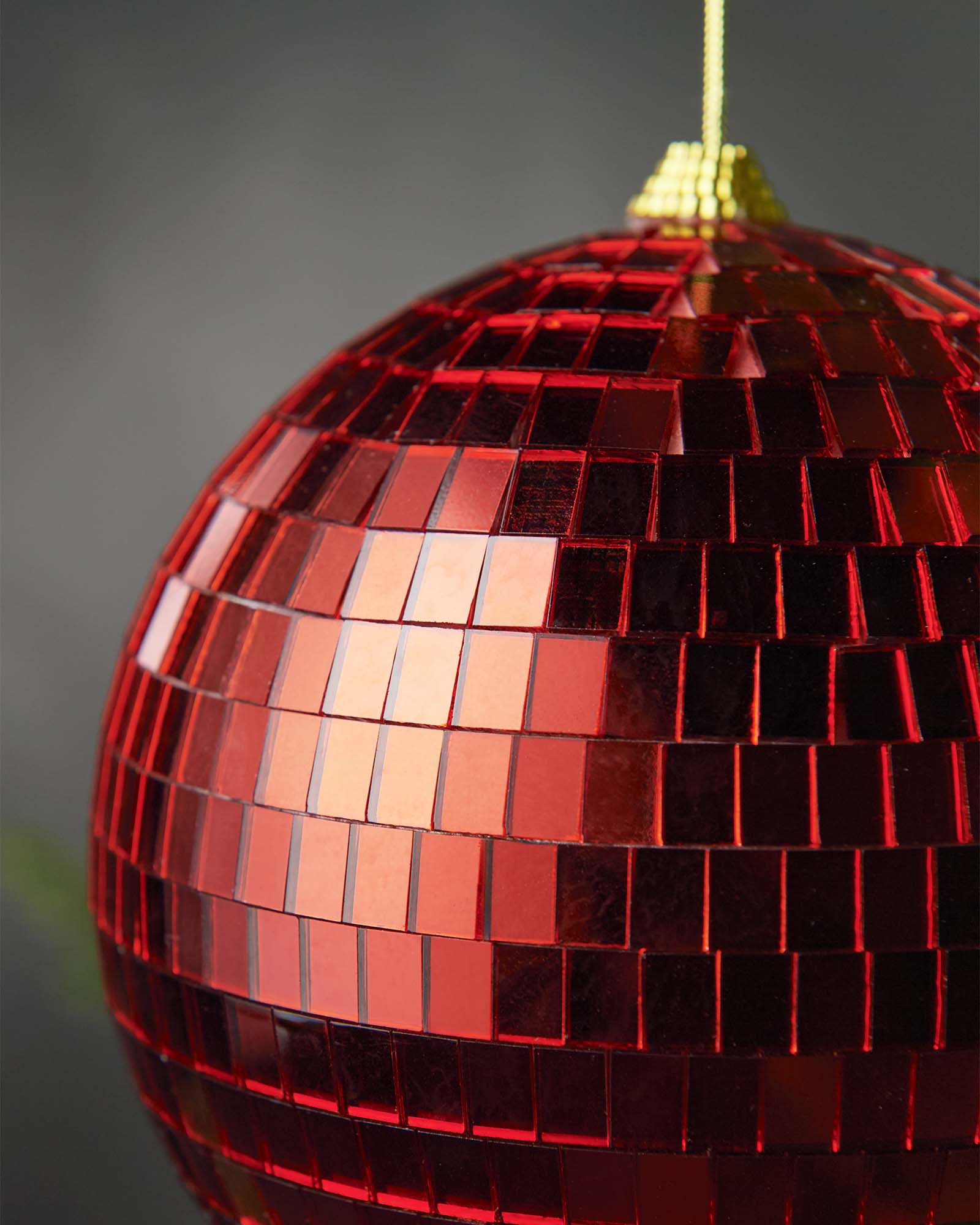 Close-up of a red 15cm disco ball bauble with mirrored square detailing.