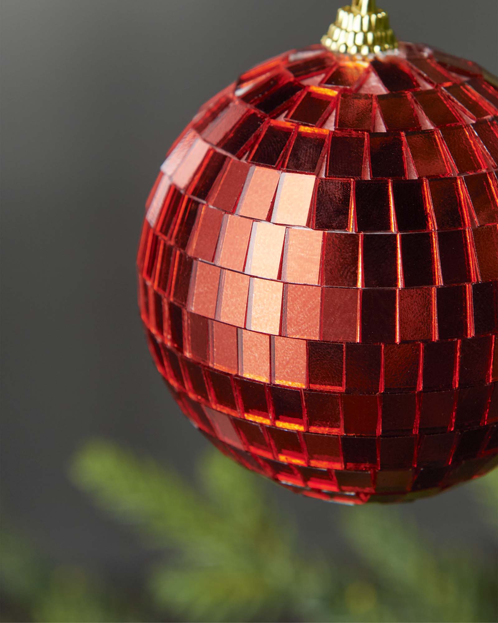 Close-up of a red 8cm disco ball bauble with mirrored square detailing.