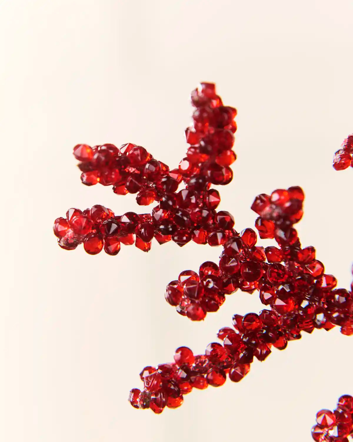 Close-up of red crystal bead clusters covering the tips of the decorative spray.