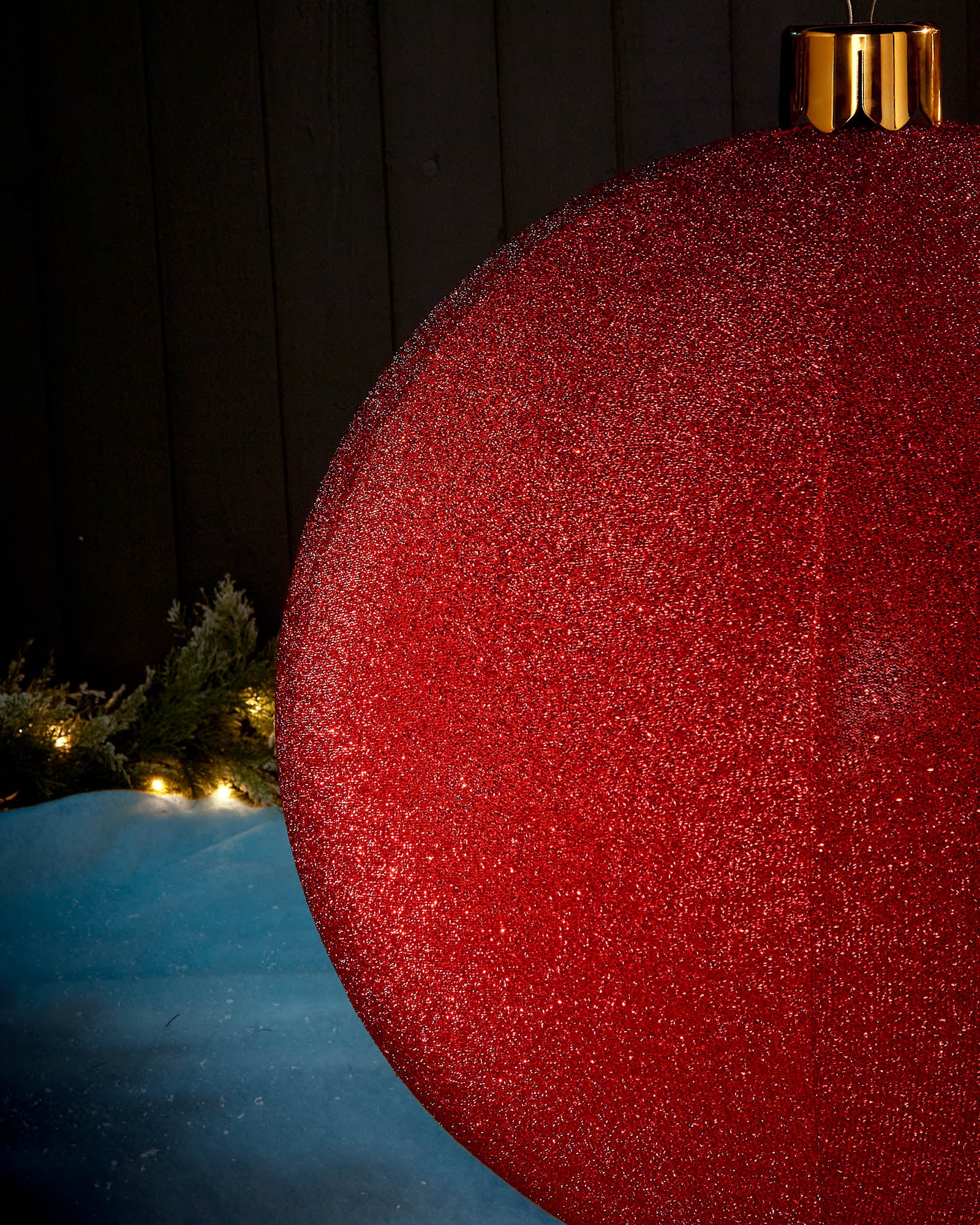 Detail close-up of the textured red tinsel surface on an inflatable Christmas bauble.
