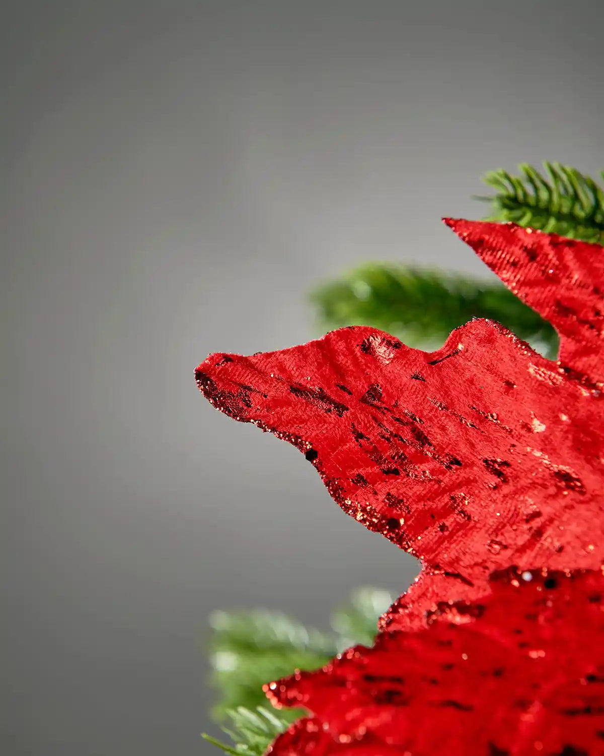 Close-up of the glittered red petals on the artificial poinsettia flower