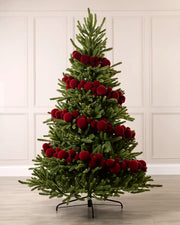 Red velvet bauble garland wrapped around a green Christmas tree with mixed 5cm, 7cm and 10cm baubles.