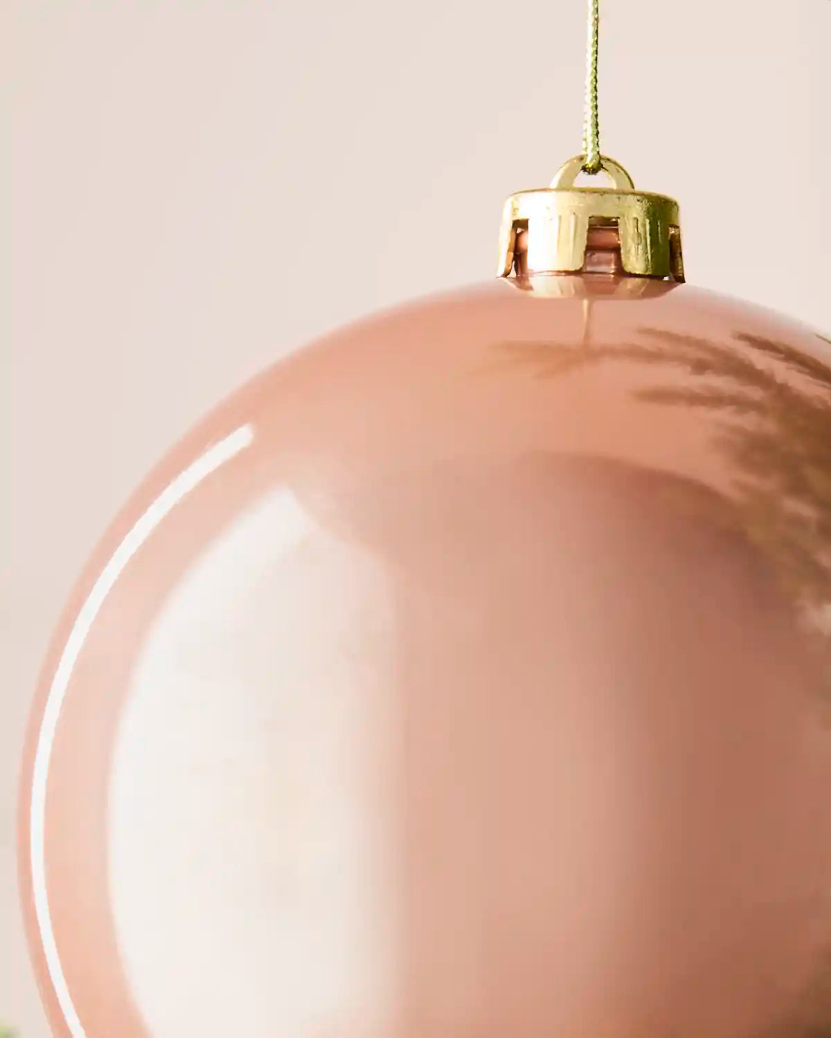 Detailed close-up of the 15 cm rose gold shiny shatterproof bauble showing the gold cap, hanging string and reflective finish.