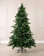 Sage green bauble cluster arch styled around a green Christmas tree with shiny, matt and glitter baubles.