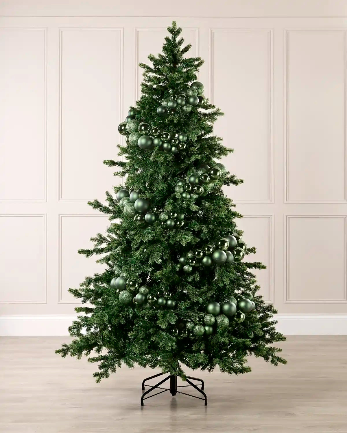 Sage green bauble cluster arch styled around a green Christmas tree with shiny, matt and glitter baubles.