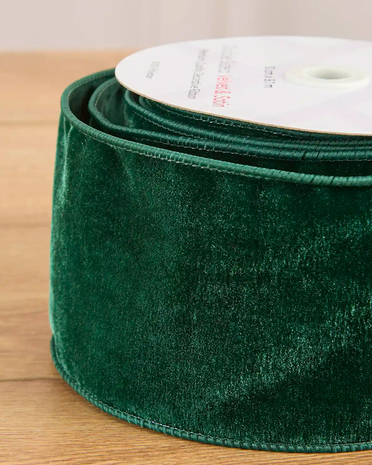 Close-up of the sage green velvet surface and wired satin edging on the 10 cm ribbon.