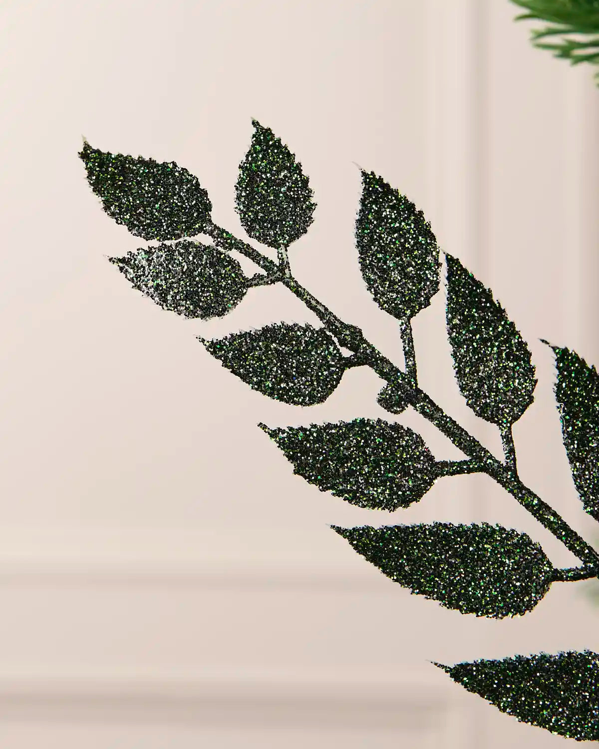 Detailed close-up of the sparkling sage green leaves on a 73 cm Christmas tree spray.