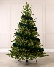 Sage green velvet bauble garland wrapped around a green Christmas tree with mixed 5cm, 7cm and 10cm baubles.