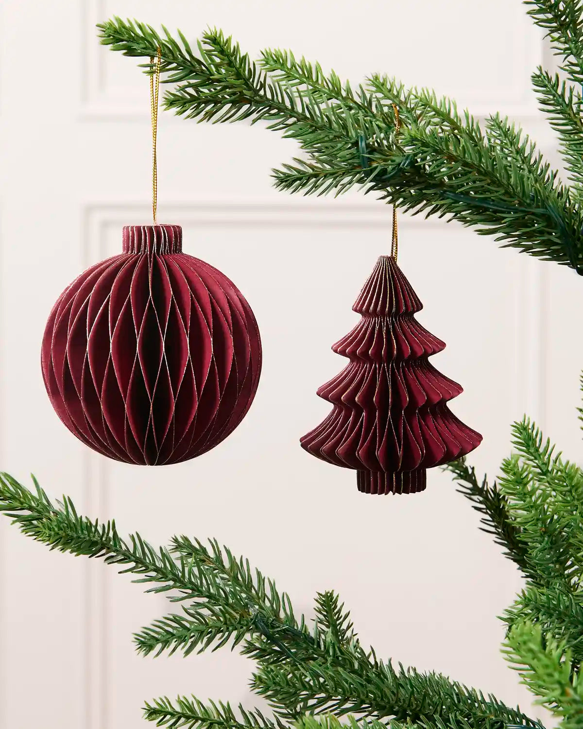 Burgundy 15 cm paper bauble and Christmas tree decoration with gold glitter edging.