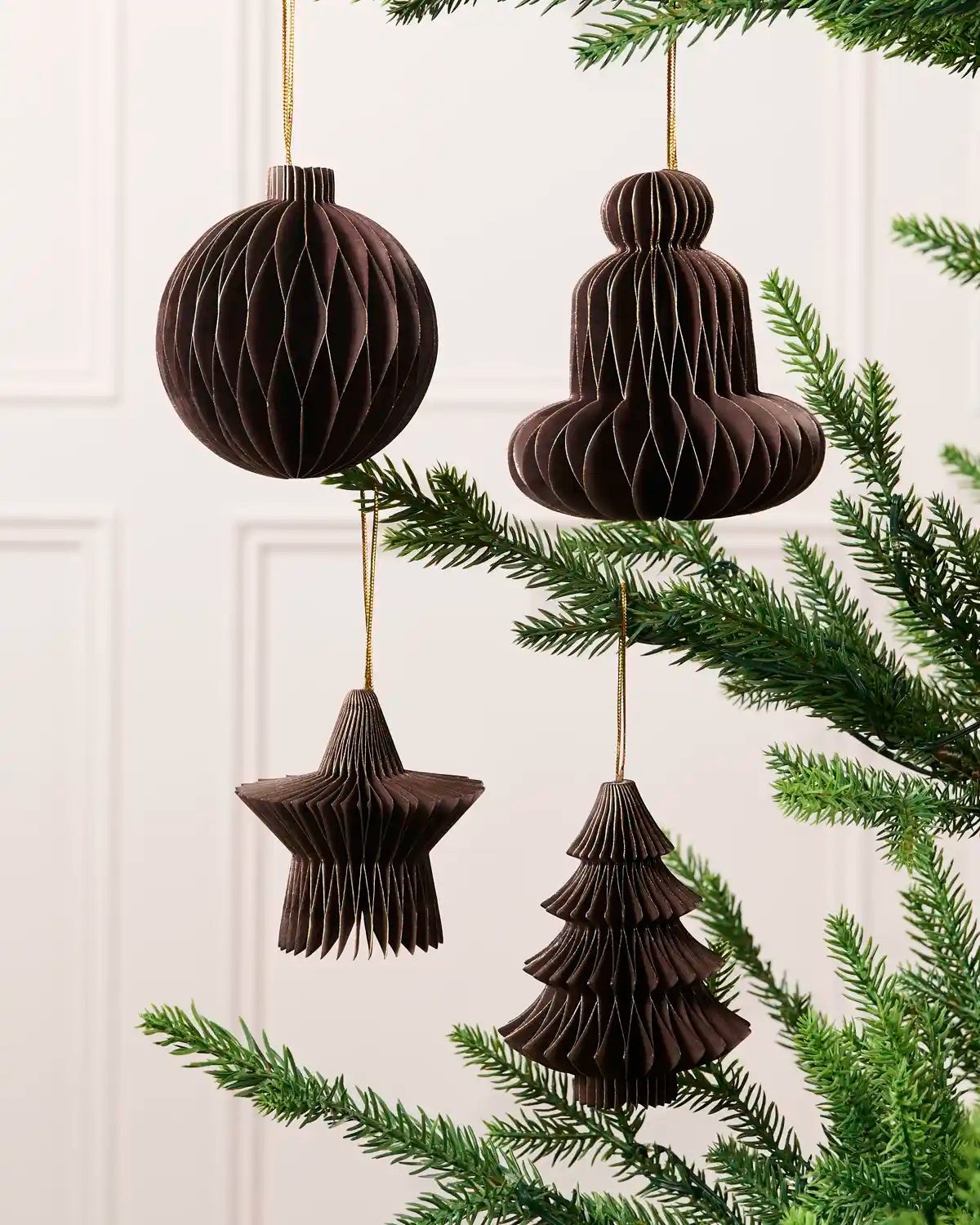 Espresso paper bauble, bell, star and Christmas tree decorations displayed on a Christmas tree.