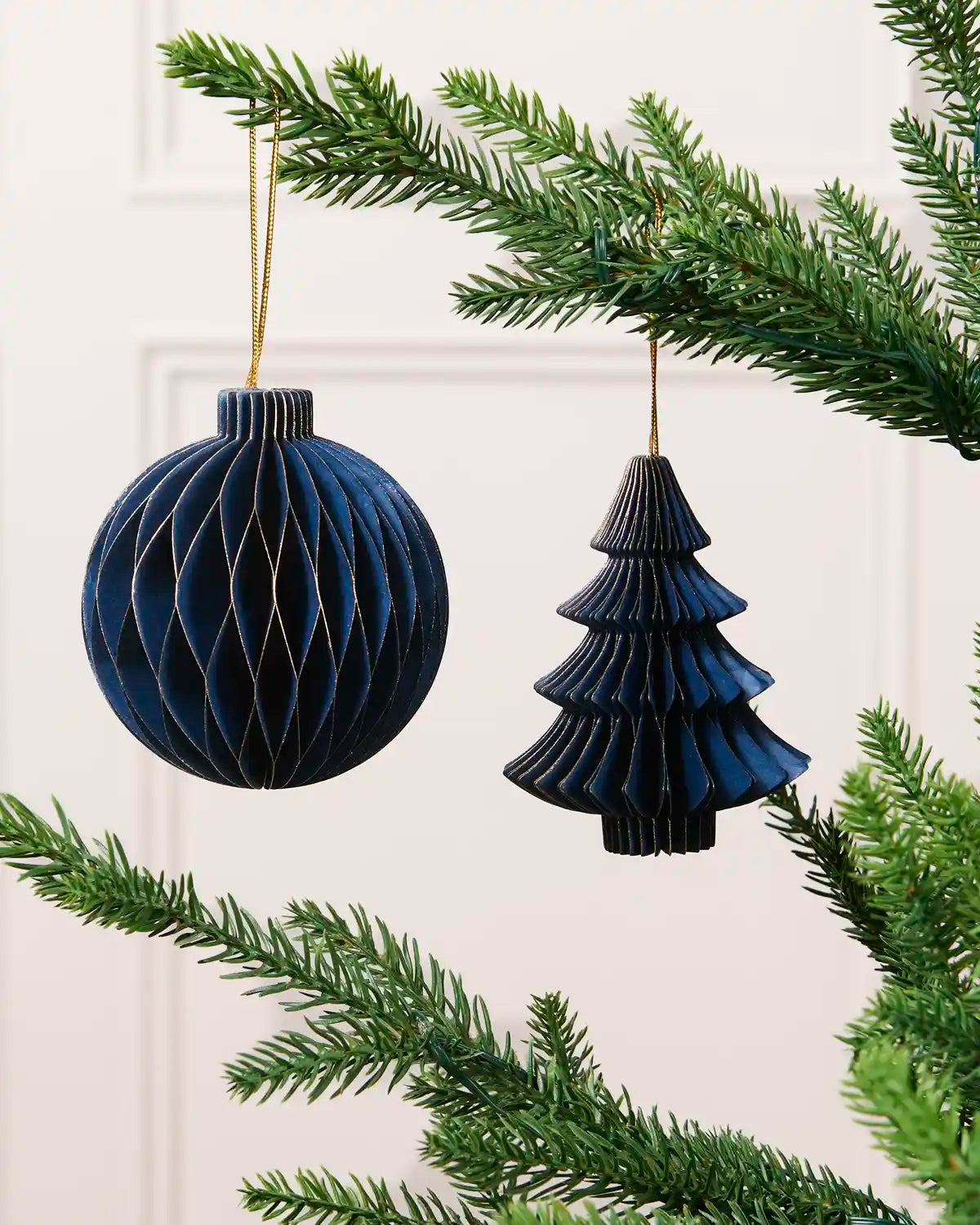 Navy 15 cm paper bauble and Christmas tree decoration with gold glitter edging.