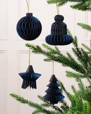 Navy paper bauble, bell, star and Christmas tree decorations displayed on a Christmas tree.