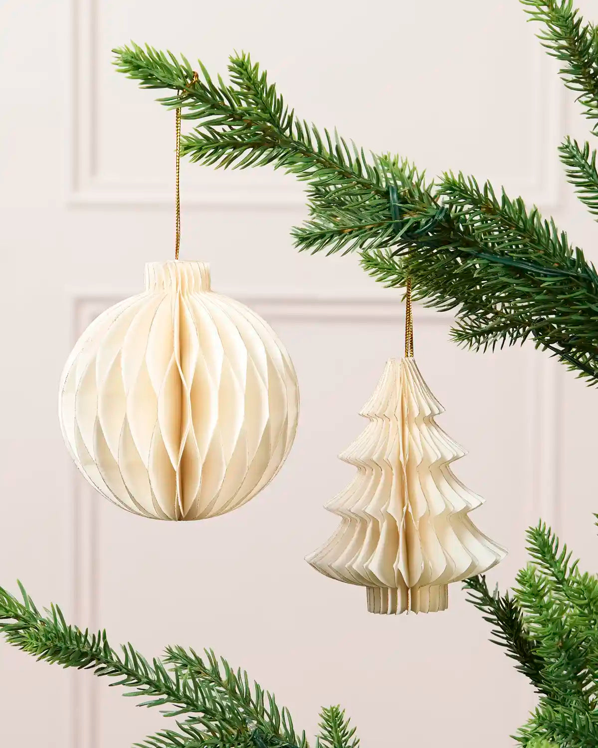 Off-white 15 cm paper bauble and Christmas tree decoration with gold glitter edging.