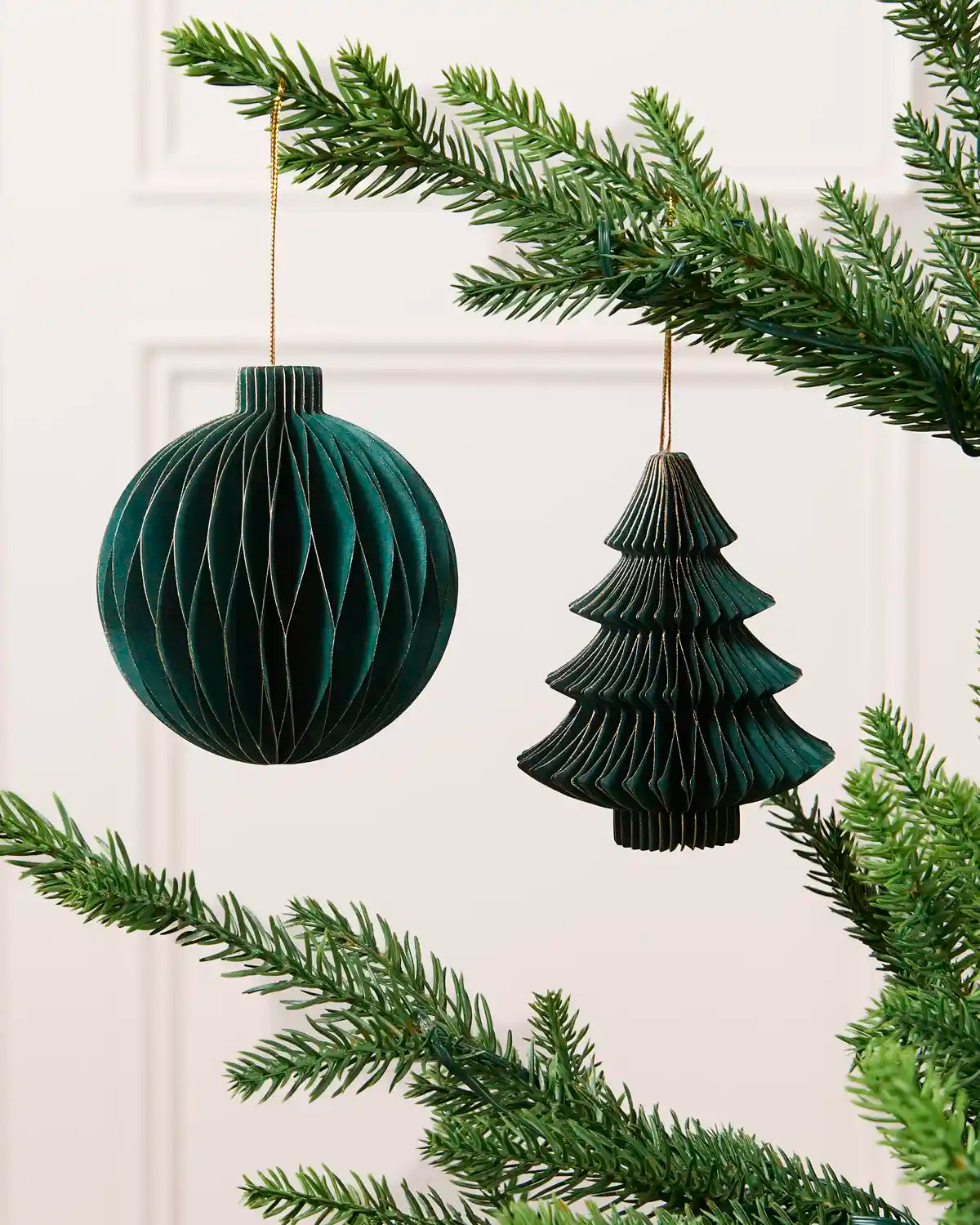Sage green 15 cm paper bauble and Christmas tree decoration with gold glitter edging.