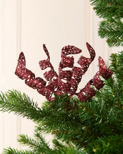 Set of three 18 cm burgundy glitter spiral picks arranged among green Christmas tree branches.