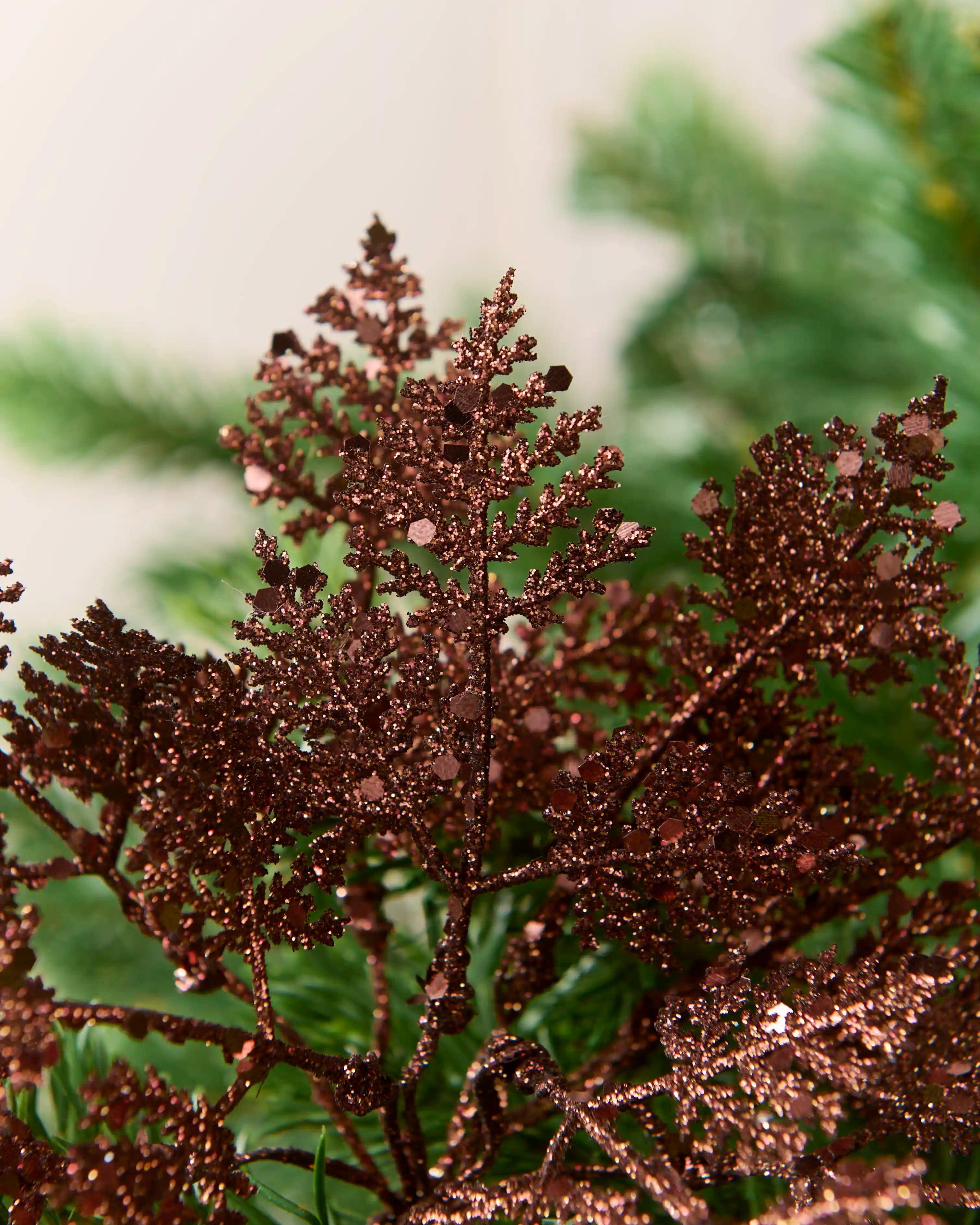 Close-up of espresso 19 cm glitter leaf picks showing their branching leaf shape and sparkling finish.
