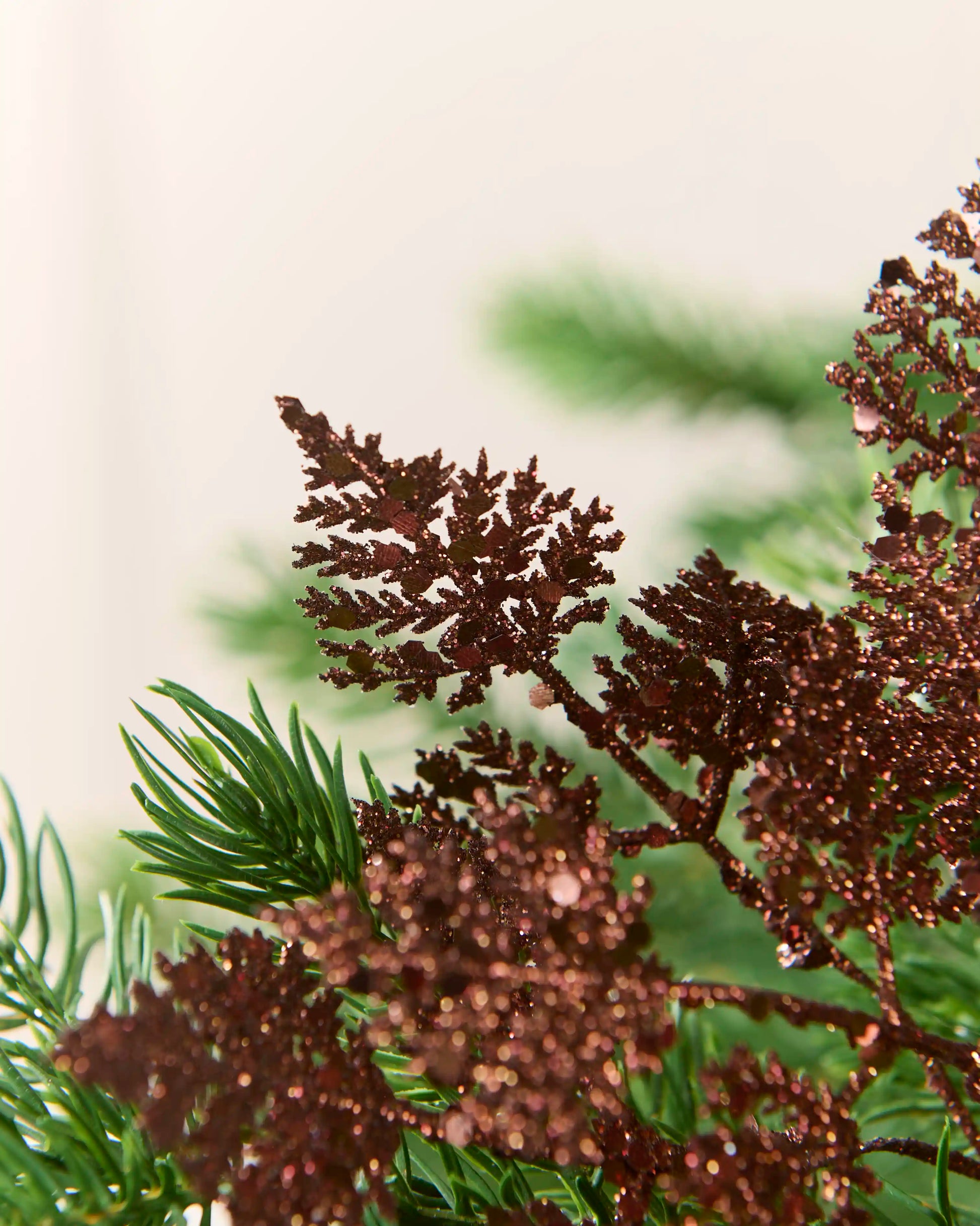 Close-up of an espresso 19 cm glitter leaf pick showing the intricate leaf shape and glittered surface.