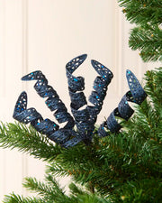 Set of three 18 cm navy glitter spiral picks arranged among green Christmas tree branches.