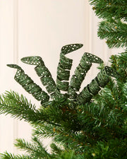 Set of three 18 cm sage green glitter spiral picks arranged among green Christmas tree branches.
