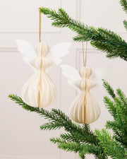 Two off-white 13 cm paper angel decorations hanging from a green Christmas tree.