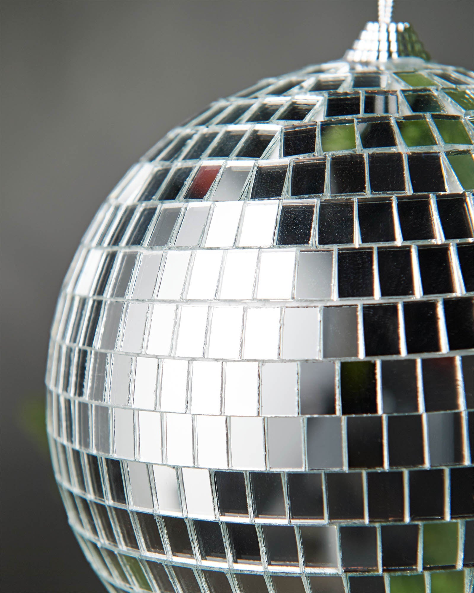Close-up of a silver 15cm disco ball bauble with mirrored square detailing.