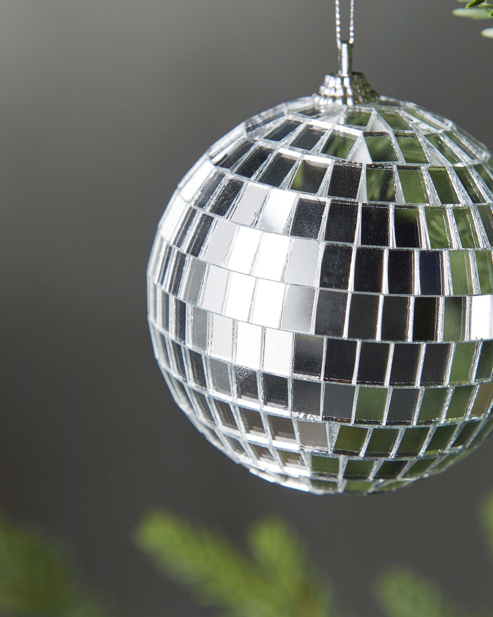 Close-up of a silver 8cm disco ball bauble with mirrored square detailing.