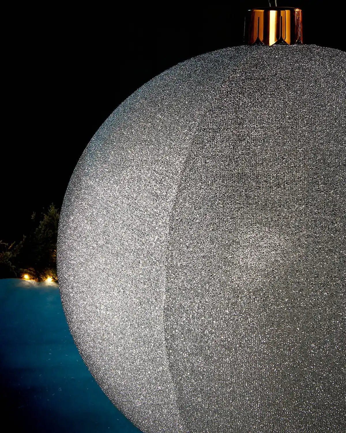 Detail close-up of the textured silver tinsel surface on an inflatable Christmas bauble.