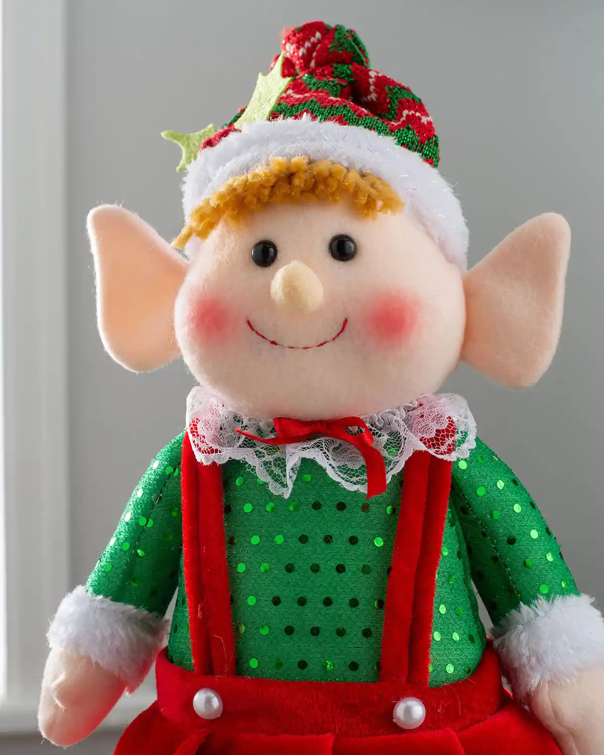 Close-up of the standing elf girl figurine with a red and green festive hat