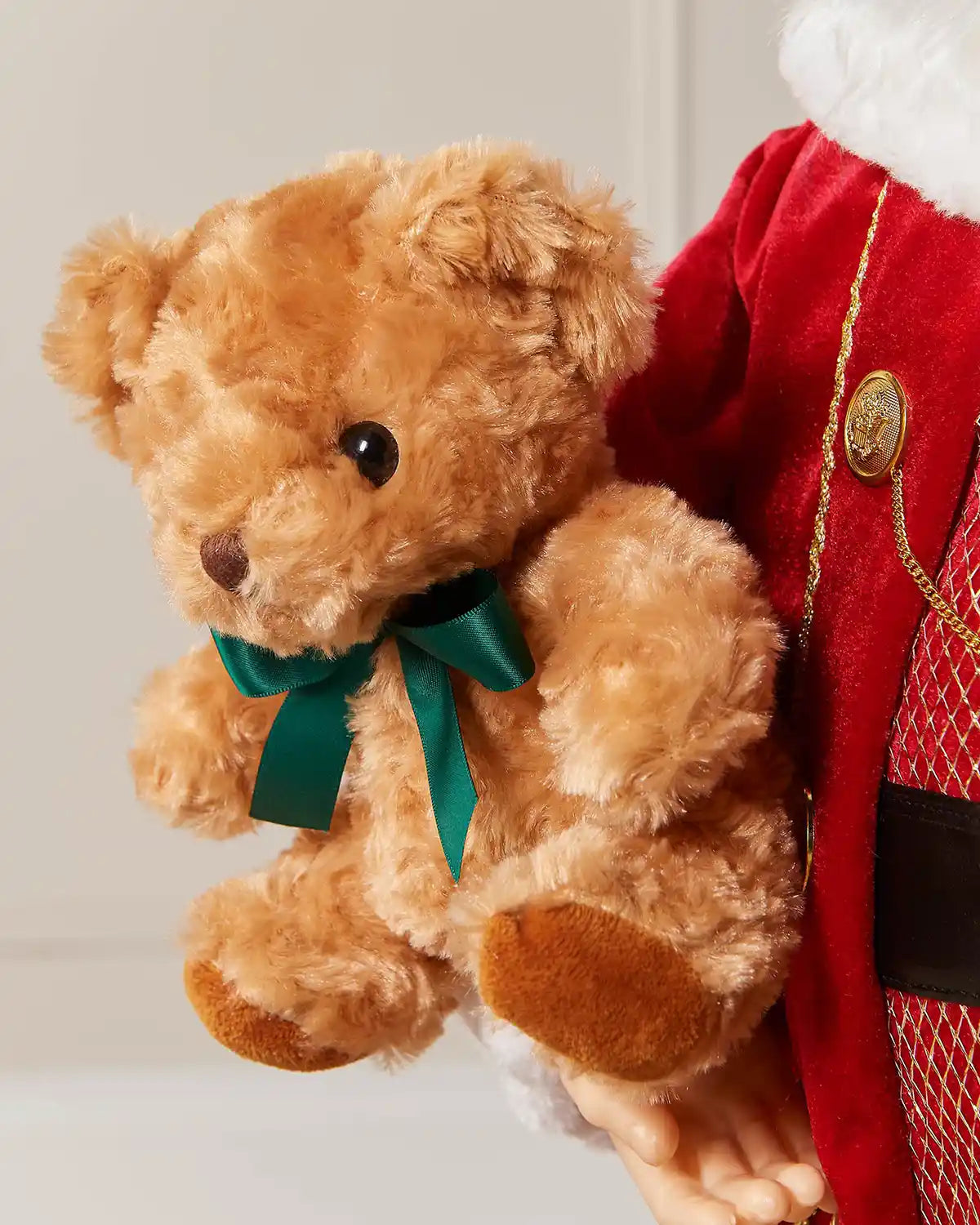Close-up of the teddy bear held by the Santa figurine